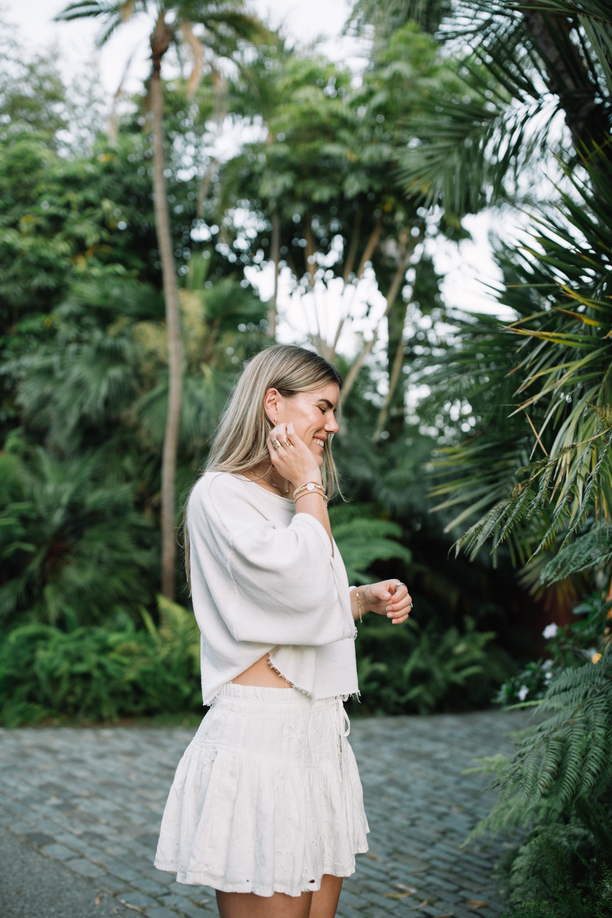 Cambria Joy smiling among lush palms